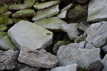 Broken up concrete covered in algae on the coast.