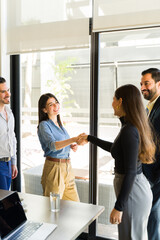 Businesspeople greeting some clients in a meeting room