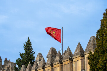 Flag over Almodovar castle (Castillo de Almodovar del Rio), a castle of Muslim origin  in Almodovar del Rio, Spain