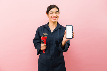 Attractive happy woman and plumber wearing blue overalls