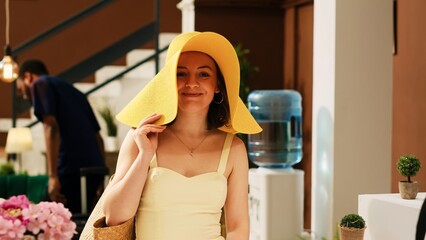 Tourist at exotic resort reception asking about booking reservation in lobby entrance. Woman guest...