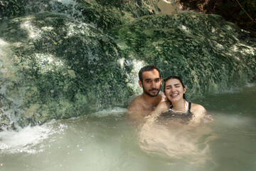 heterosexual couple having fun and relaxing in hot springs on the touristic trip to the caves of Tolantongo in Hidalgo Mexico photography with natural light