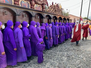 ¨Cucuruchos¨ (penitents) carrying on shoulders the heavy wooden float of the procession of La Merced, Antigua Guatemala during Good Friday. Holy Week , Semana santa