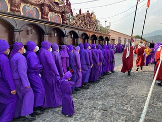 ¨Cucuruchos¨ (penitents) carrying on shoulders the heavy wooden float of the procession of La Merced, Antigua Guatemala during Good Friday. Holy Week , Semana santa