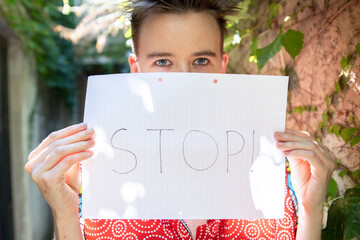 Defender of Equality: Young Female Holds Stop Sign for Women's Rights