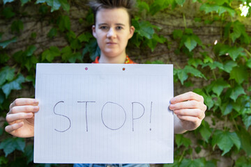 Activism in Action: Young Woman Holds Stop Sign for Women's Rights