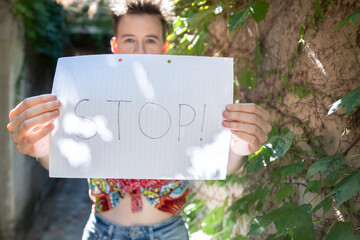 Defender of Equality: Young Female Holds Stop Sign for Women's Rights. Copy space.