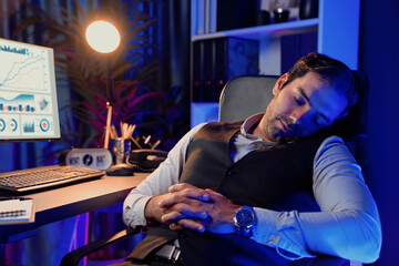 Smart businessman leaning on chair with working desk, unfinished product service sales channel report, waiting for market data long time updated at purple neon dark light room at late night. Surmise.