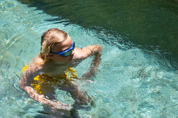 Teenager has fun in the pool on vacation.