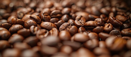 Obraz premium A pile of unprocessed coffee beans neatly stacked on top of each other, ready for the roasting process.