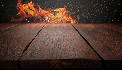 wood table on blurred fire background .