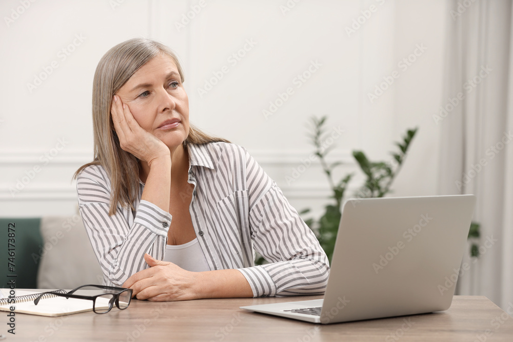 Canvas Prints Menopause, mood changes. Sad woman at wooden table indoors