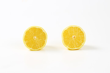 Two fresh lemon halves - 746175027