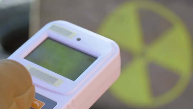 Use radiation geiger counter. Checks level of radiation. Radiation yellow danger sign in radioactive zone. Nuclear weapons, atomic apocalypse concept