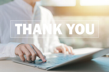 businessman using a laptop sends the message thank you on a display screen. concept of thank you...