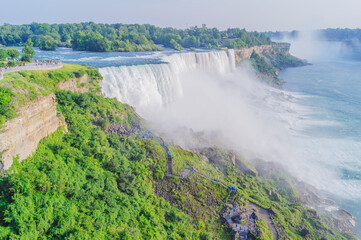 Niagara Falls, American side. The cascade of water's immense power and beauty contrasting with the...