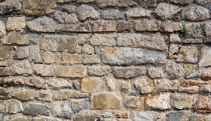 Background Stone wall in natural colors; an old building; ancient architecture