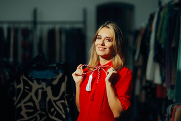 Cheerful Woman with Red and White Martisor Accessory Bow. Client in a fashion store celebrating...