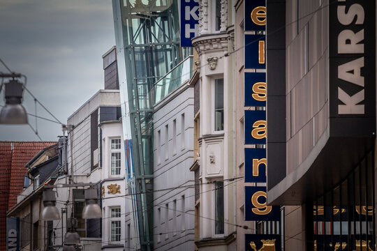 DORTMUND, GERMANY - NOVEMBER 5, 2022: Selective blur on a signs of boutiques in Westenhellweg street with shops & stores. Westenhellweg is a shopping street, high street of Dortmund altstadt, Old Town
