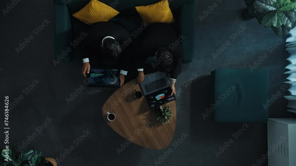 Aufkleber top down aerial view of project manager walking to workspace and working on laptop while colleague h
