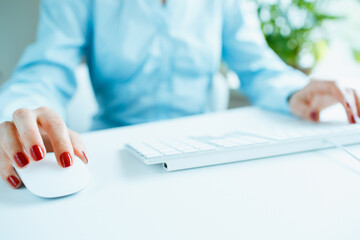 Woman office worker typing on the keyboard