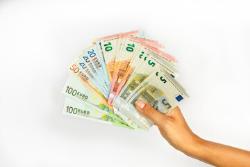 Hand holding Euro money with different face value on white