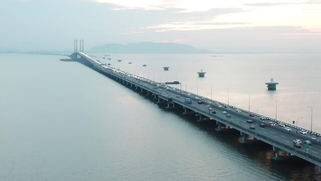 Aerial footage of Penang Bridge and TNB Monopole Transmission Tower construction. Construction and Transportation industry. Landmark and iconic structure. Megastructure bridge. Connecting roadways.