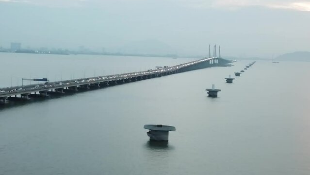 Aerial footage of Penang Bridge and TNB Monopole Transmission Tower construction. Construction and Transportation industry. Landmark and iconic structure. Megastructure bridge. Connecting roadways.