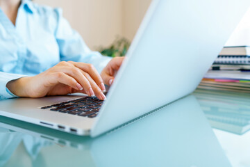 Closeup female hands on laptop keyboard