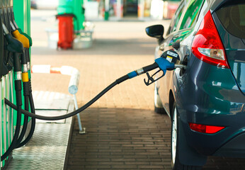 Car refueling on a petrol station close up - obrazy, fototapety, plakaty