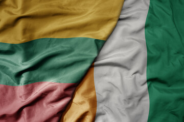 big waving national colorful flag of cote divoire and national flag of lithuania .