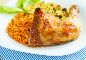 Delicious dish of chicken thigh with rice and salad leaves