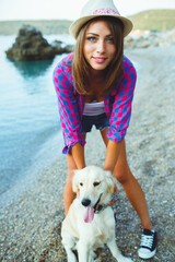 Woman with a dog on a walk on the beach