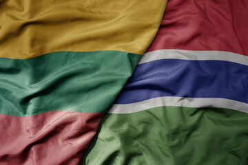 big waving national colorful flag of gambia and national flag of lithuania .