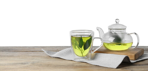 Refreshing green tea in cup and teapot on wooden table against white background