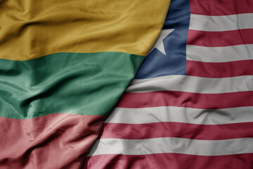 big waving national colorful flag of liberia and national flag of lithuania .