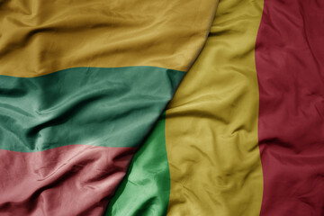 big waving national colorful flag of mali and national flag of lithuania .