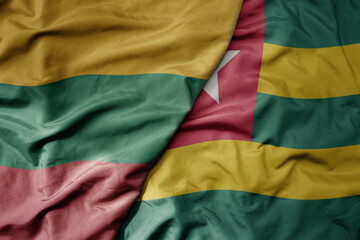 big waving national colorful flag of togo and national flag of lithuania .