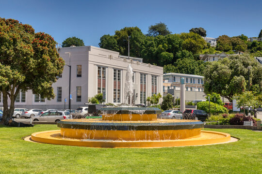 Napier, Hawkes Bay, New Zealand - Art deco style buildings and the Tait Fountain fountain in the centre of Napier, and a view to some hillside homes.
