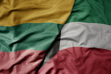 big waving national colorful flag of kuwait and national flag of lithuania .