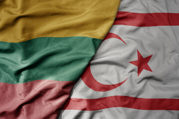 big waving national colorful flag of northern cyprus and national flag of lithuania .