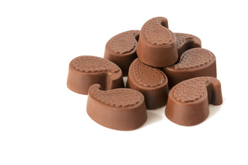 Milk chocolate candies lie on a white isolated background.