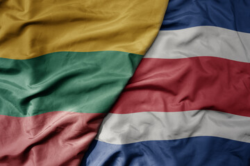 big waving national colorful flag of costa rica and national flag of lithuania .
