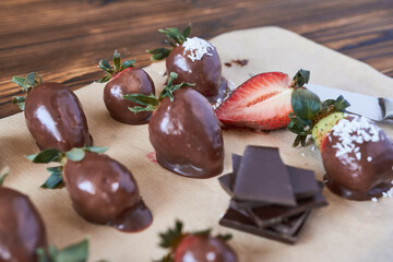 Chocolate-covered strawberries.   Chocolate covered strawberries with dark chocolate and mint. Preparation of dessert.