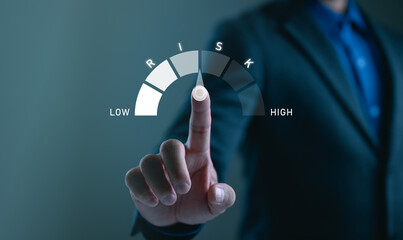 Businessman showing risk level indicator rating since low to high for risk management and assessment review concept. Business and finance concept, CEO manager management.