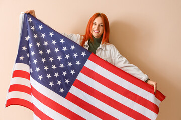 Young woman with USA flag on beige background