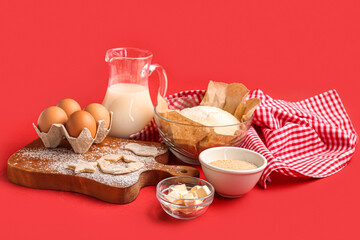 Composition with ingredients for preparing tasty cookies on red background