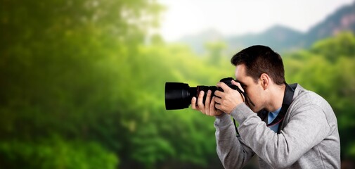 Fototapeta na wymiar Photographer hold camera taking pictures outdoor