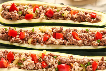 Meat stuffed zucchini boats on table