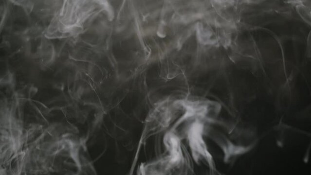 Smoke on black background. Smoking, steam clouds of vapour close-up. Burning, fog